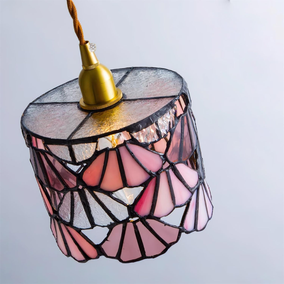 Pendant Light With Brass Accents And Glass Shade For Warm Glow