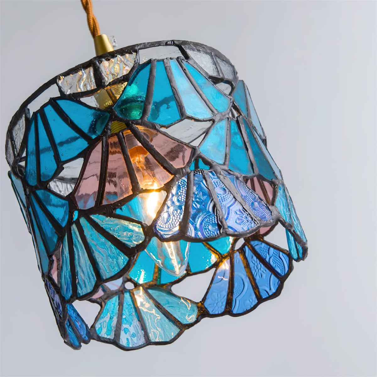 Pendant Light With Brass Accents And Glass Shade For Warm Glow