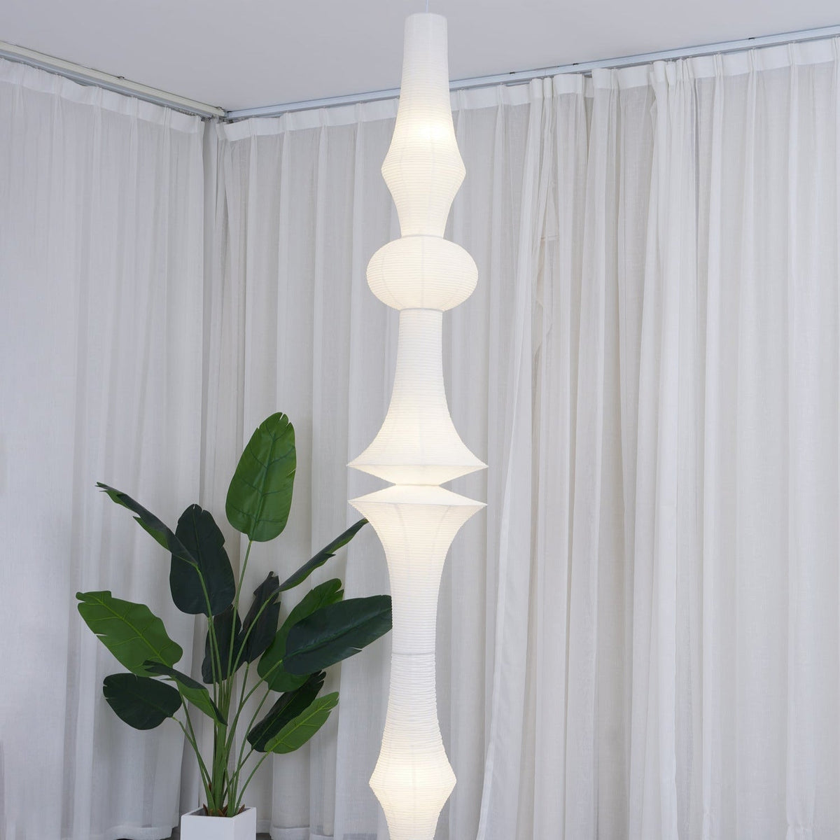 Vertical Sculptural Pendant Light With Warm Paper Glow
