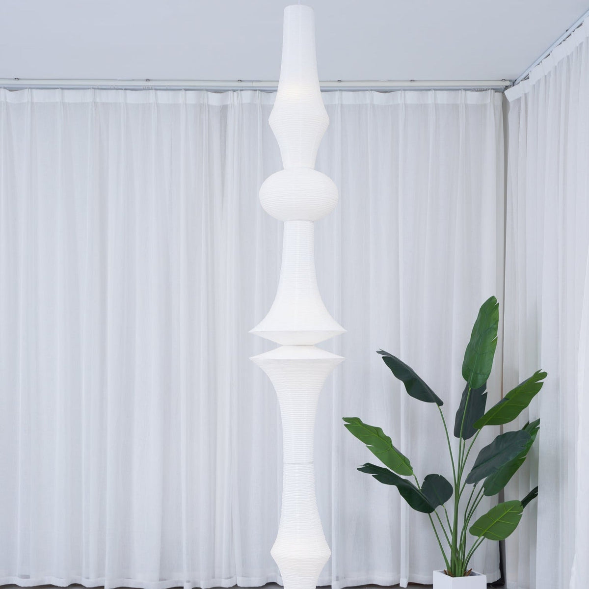 Vertical Sculptural Pendant Light With Warm Paper Glow
