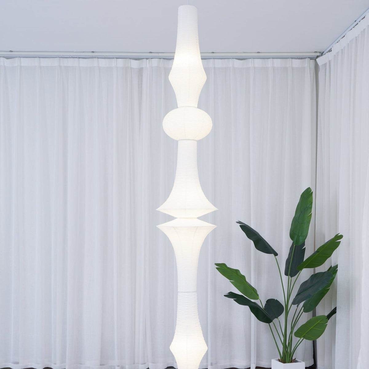 Vertical Sculptural Pendant Light With Warm Paper Glow