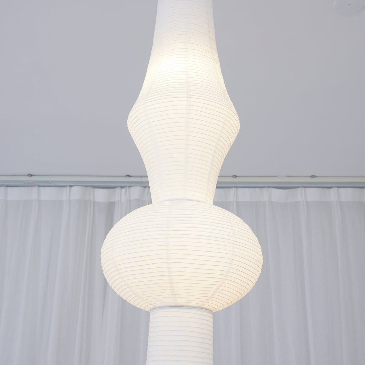 Vertical Sculptural Pendant Light With Warm Paper Glow