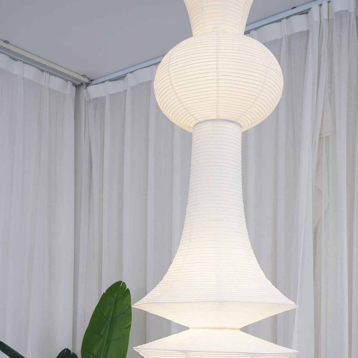 Vertical Sculptural Pendant Light With Warm Paper Glow